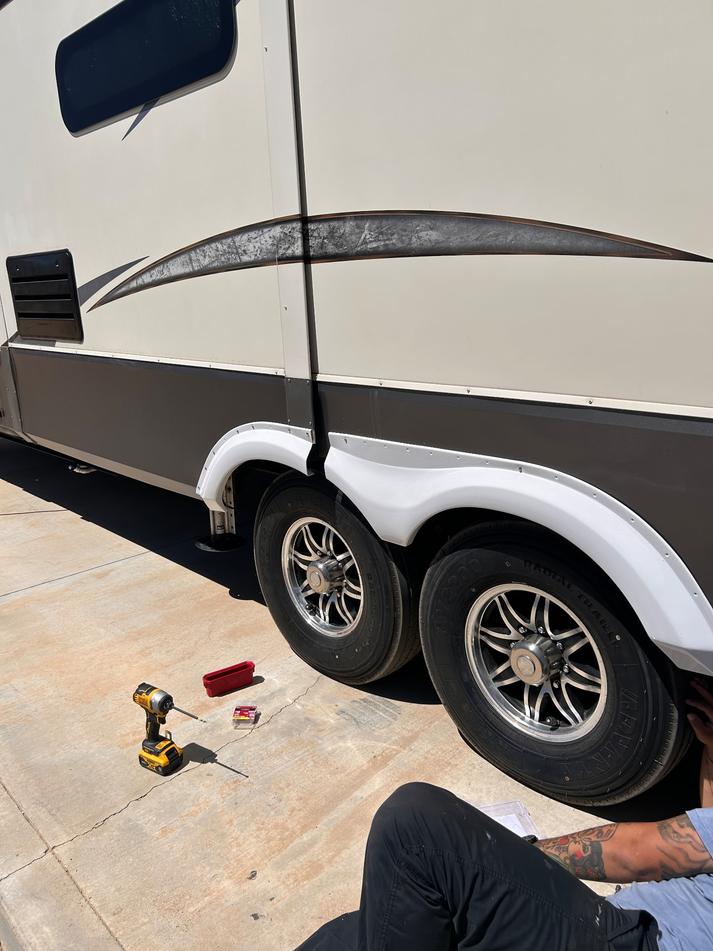 Technician checking the exterior of a fifth wheel RV